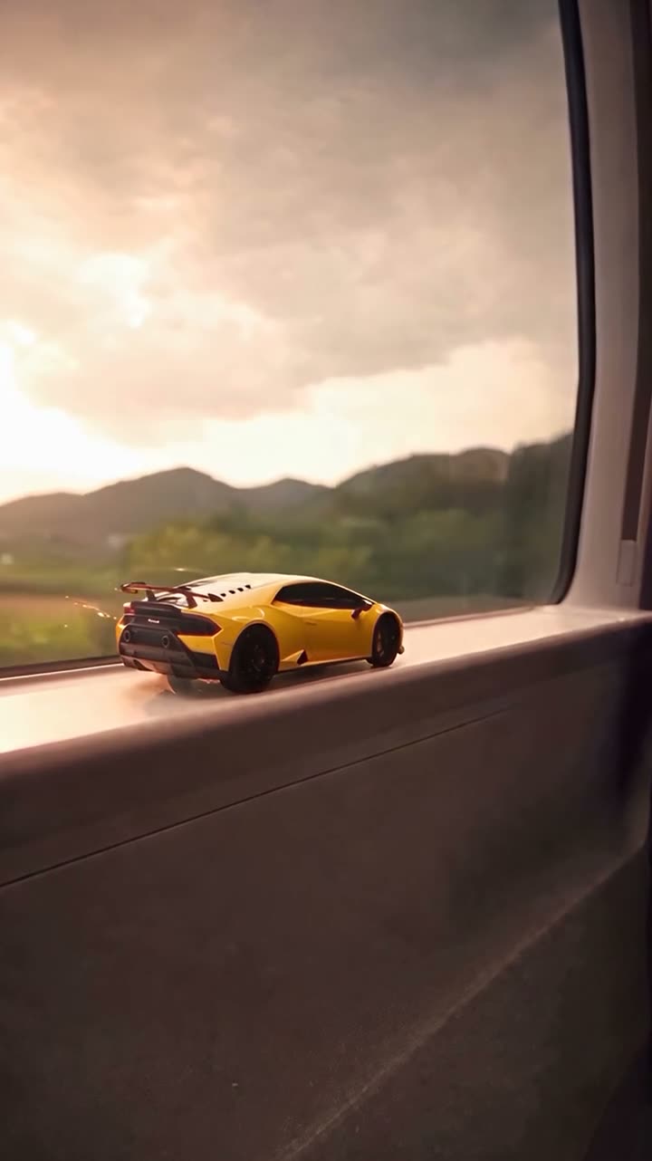 Frame at 2 seconds from the Vellm example video made from test photos: the toy version of a yellow sports car rides a train window ledge at sunset.
